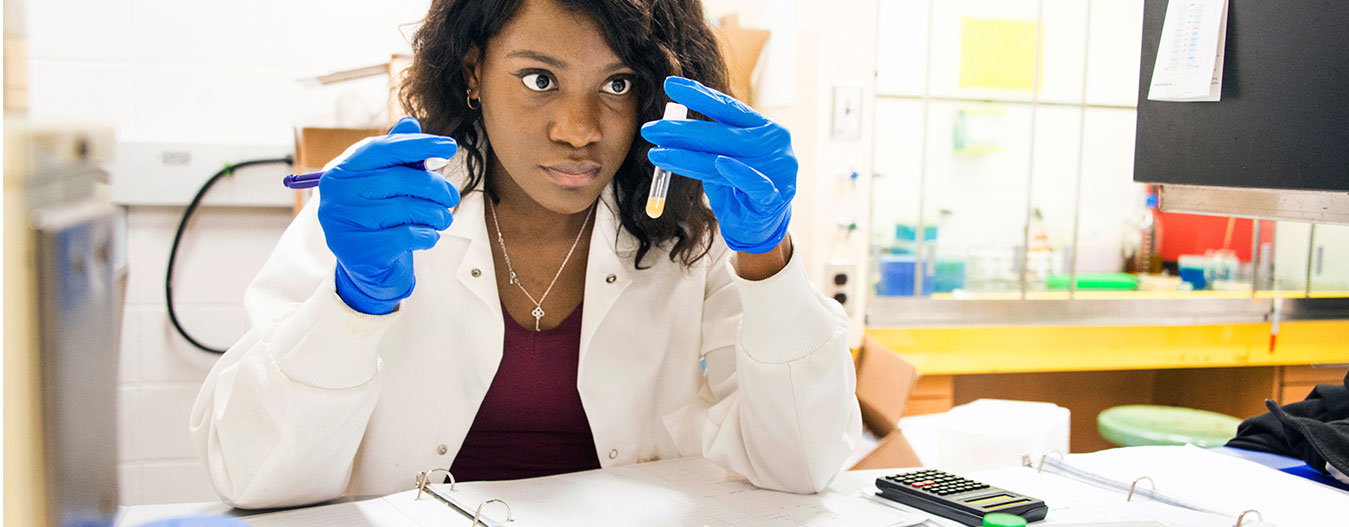Student holding laboratory samples